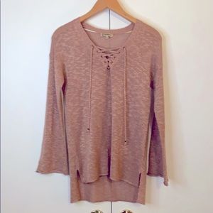 Rose knit sweater with gold stitching.